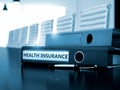 Health Insurance on Office Folder. Toned Image. 3D Render. Royalty Free Stock Photo