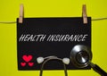 HEALTH INSURANCE on top of yellow background Royalty Free Stock Photo