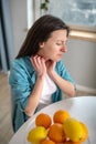 Young woman being alergic to citrus fruit