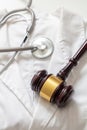 Health and Law. Medical malpractice, personal injury lawyer. Judge gavel and doctor stethoscope Royalty Free Stock Photo