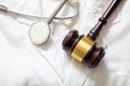 Health and Law. Medical malpractice, personal injury lawyer. Judge gavel and doctor stethoscope Royalty Free Stock Photo