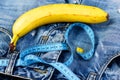 Kinky fruit with blue measure tape on jeans, close up