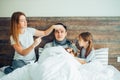 Caucasian woman measures temperature of man on bed Royalty Free Stock Photo