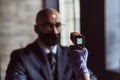 Health officer checking temperature of a businessman in the entrance of the business center. Businessman must go through Royalty Free Stock Photo