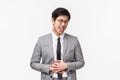 Health, people and lifestyle concept. Portrait of asian young man in grey suit feeling unwell, have diarrhea, sick after