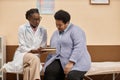 Health Practitioner Showing Lab Report to Patient on Tablet Royalty Free Stock Photo