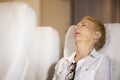 Health problem on an airplane, The senior female passenger on the plane felt shoulder pain from a long plane ride Royalty Free Stock Photo