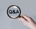 Health Q and A concept. Questions and answers about medicare. Medical QA, QnA through ,agnifying glass in doctor hand Royalty Free Stock Photo