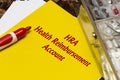 Health Reimbursement Account HRA, the text is written in red letters on a yellow sheet