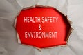 HEALTH, SAFETY AND ENVIRONMENT CONCEPT text at plain torn paper. Royalty Free Stock Photo