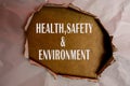 HEALTH, SAFETY AND ENVIRONMENT CONCEPT text at plain torn paper. Royalty Free Stock Photo