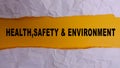 HEALTH, SAFETY AND ENVIRONMENT CONCEPT text at plain torn paper. Royalty Free Stock Photo