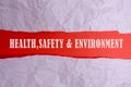 HEALTH, SAFETY AND ENVIRONMENT CONCEPT text at plain torn paper. Royalty Free Stock Photo