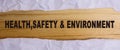 HEALTH, SAFETY AND ENVIRONMENT CONCEPT text at plain torn paper. Royalty Free Stock Photo