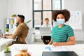 African american woman in medical mask at office