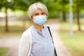 Senior woman in protective medical mask in park Royalty Free Stock Photo