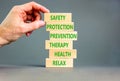 Health and safety symbol. Concept words Safety Protection Prevention Therapy Health Relax on wooden blocks on a beautiful grey