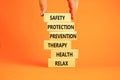 Health and safety symbol. Concept words Safety Protection Prevention Therapy Health Relax on wooden blocks on a beautiful orange