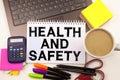 Health and Safety text in the office with surroundings such as laptop, marker, pen, stationery, coffee. Business concept for Aware