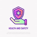 Health and safety thin line icon: hand holding shield with medical symbol. Modern vector illustration