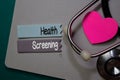 Health Screening write on stick note isolated on Office Desk. Healthcare concept Royalty Free Stock Photo