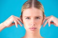 Health, spa and beauty concept - clean face of beautiful young woman pointing to her ear Royalty Free Stock Photo