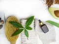 Health spa with massage serum, scrub, avocado, green aloe vera, leaf, massage acessories, towel, glove, brush on white background