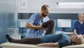 Health specialist using leg raise procedure to crack bones Royalty Free Stock Photo