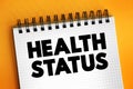Health Status - individual`s relative level of wellness and illness, text concept on notepad Royalty Free Stock Photo