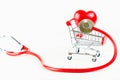 Health stethoscope red and plastic red heart on shopping cart isolated on white background,health care concept Royalty Free Stock Photo