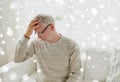 Senior man suffering from headache at home Royalty Free Stock Photo