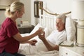 Health Visitor Giving Senior Male Hot Drink In Bed At Home Royalty Free Stock Photo