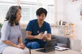 A health visitor is seen with a tablet, explaining to a senior woman how to take her pills. Royalty Free Stock Photo