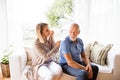 Health visitor and a senior man during home visit. Royalty Free Stock Photo