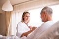 Health visitor and a senior man during home visit. Royalty Free Stock Photo