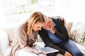 Health visitor and a senior man with tablet during home visit. Royalty Free Stock Photo