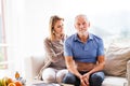 Health visitor and a senior man during home visit. Royalty Free Stock Photo