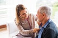 Health visitor and a senior man during home visit. Royalty Free Stock Photo