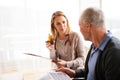 Health visitor and a senior man with tablet during home visit. Royalty Free Stock Photo