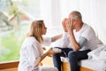 Health visitor and a senior man during home visit. Royalty Free Stock Photo