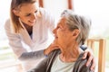 Health visitor and a senior woman during home visit. Royalty Free Stock Photo