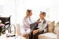 Health visitor and a senior woman during home visit. Royalty Free Stock Photo