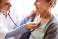 Health visitor and a senior woman during home visit. Royalty Free Stock Photo