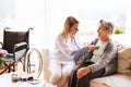 Health visitor and a senior woman during home visit. Royalty Free Stock Photo