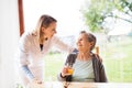 Health visitor and a senior woman during home visit. Royalty Free Stock Photo