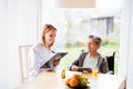 Health visitor and a senior woman with tablet. Royalty Free Stock Photo