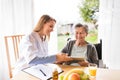 Health visitor and a senior woman with tablet. Royalty Free Stock Photo