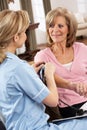 Health Visitor Taking Woman's Blood Pressure