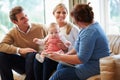 Health Visitor Talking To Family With Young Baby Royalty Free Stock Photo