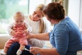 Health Visitor Talking To Mother With Young Baby